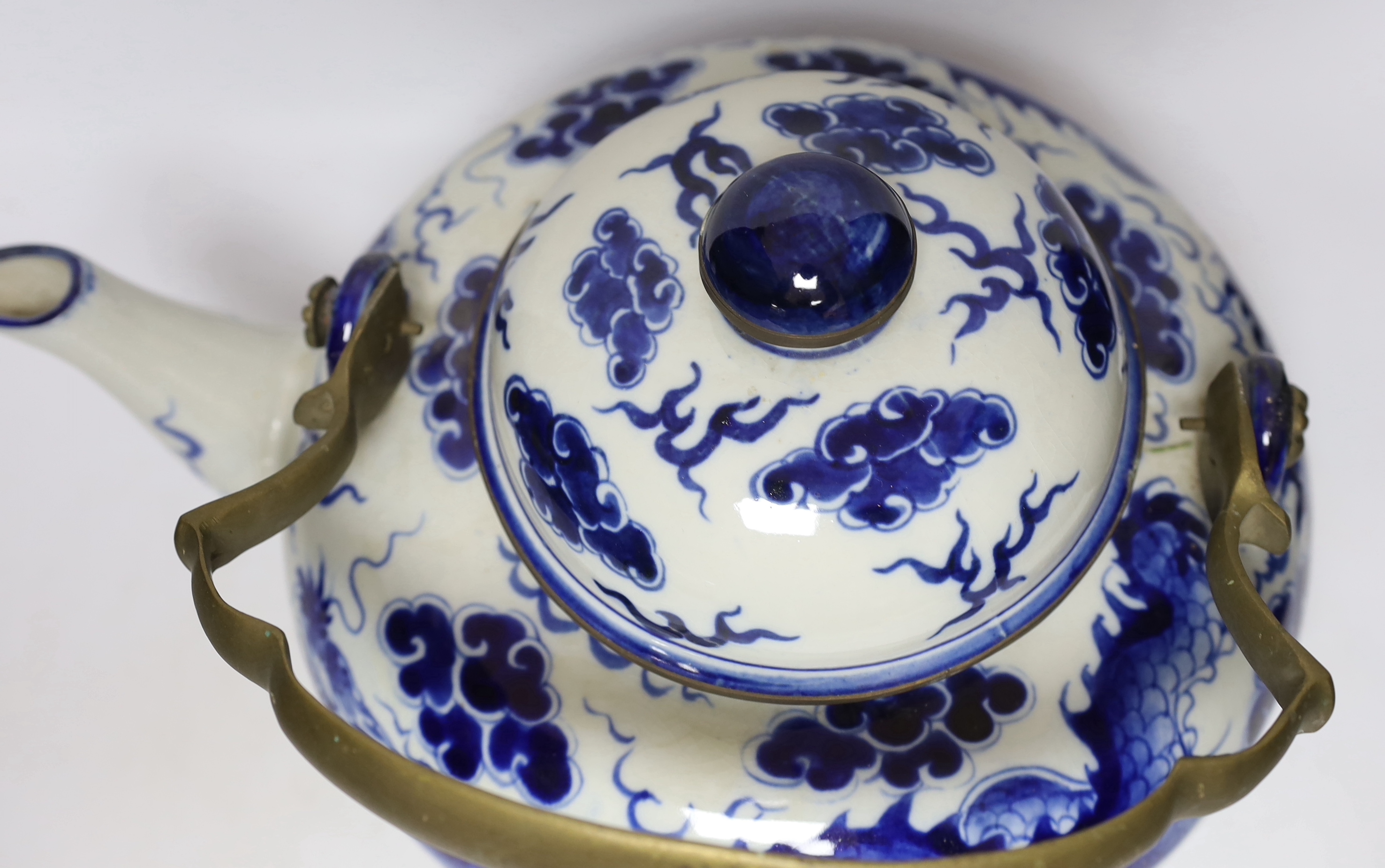 A large Chinese blue and white ‘dragon’ teapot, 38cm wide